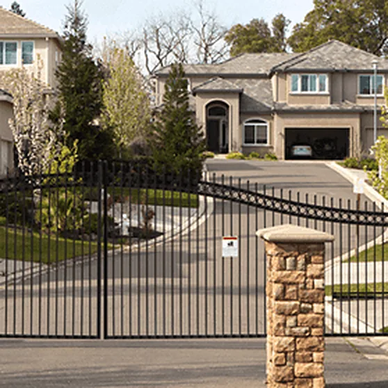 Ornamental iron driveway gate at a residential estate entrance
