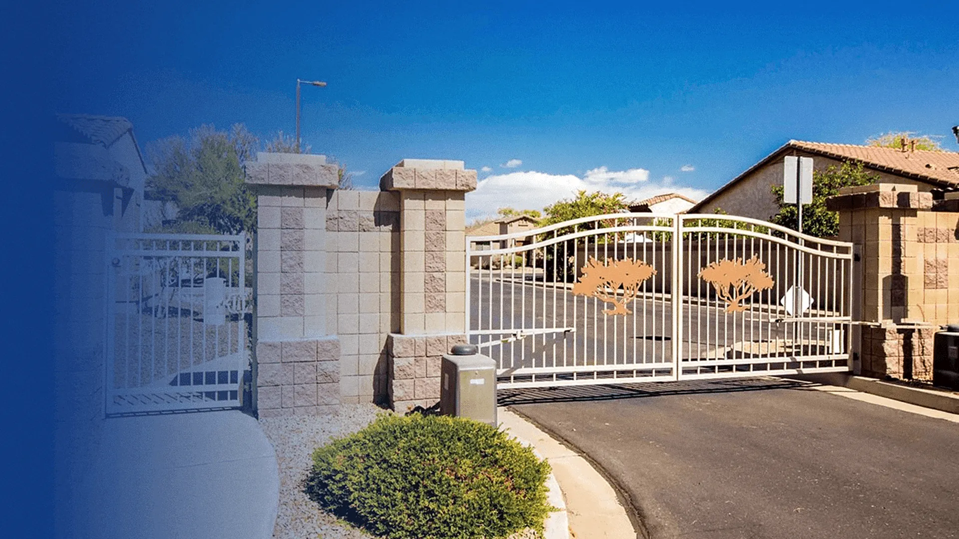 Double swing gate with tree-motif panels at a community vehicle entrance, with a keypad pedestal in front