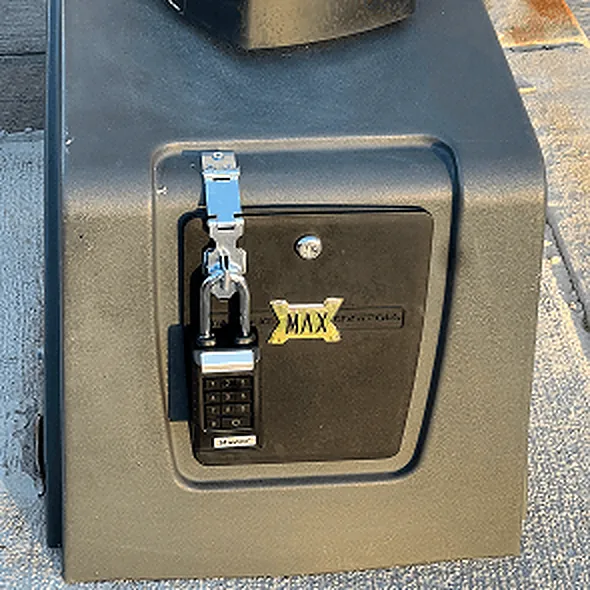 Keypad lock box latched to a gate operator housing