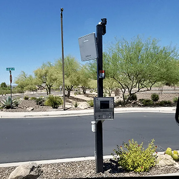 Call box and reader on a pedestal at a community vehicle entrance