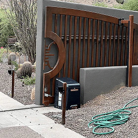 Wood-and-steel swing gate with its operator housing in a cactus garden